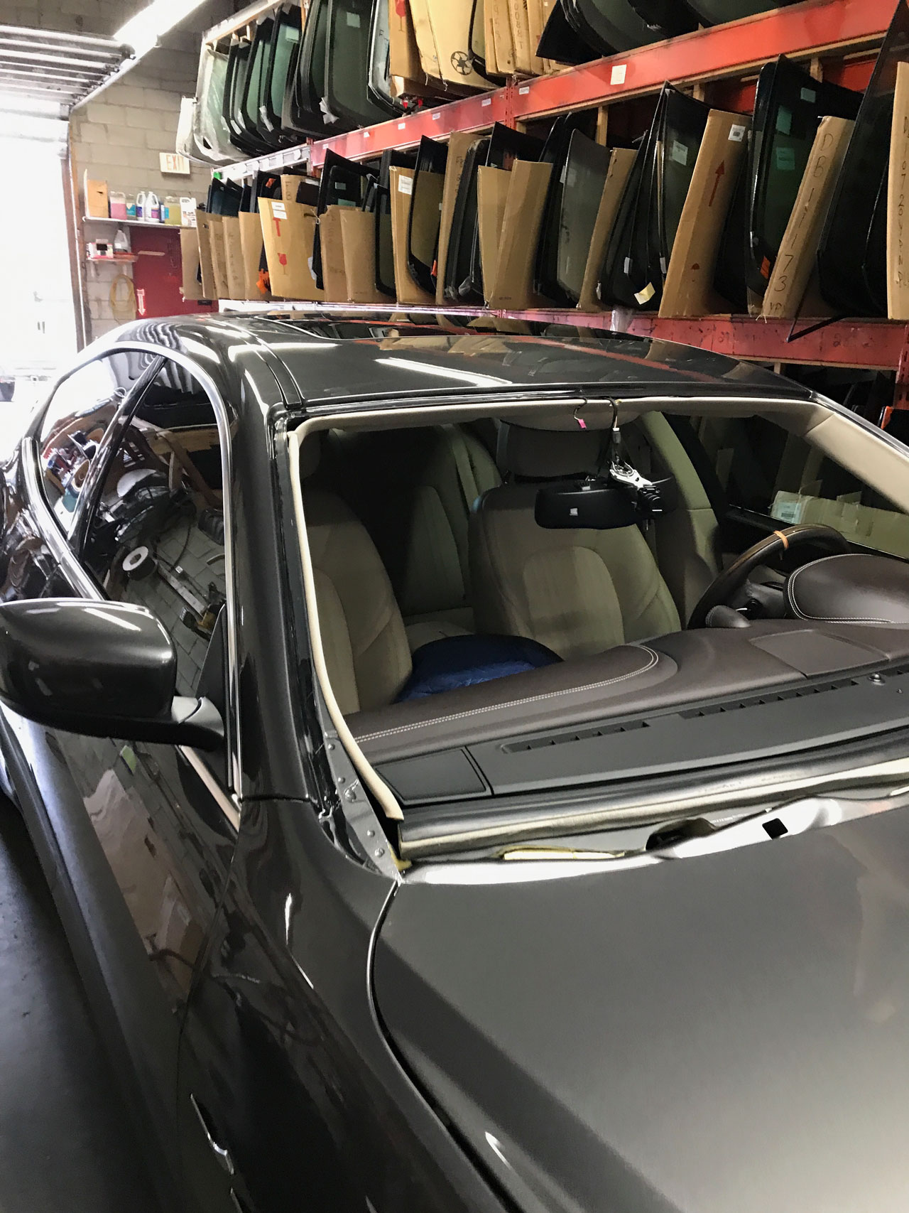 closed up Ghibli removed front windshield beside stock glass rack